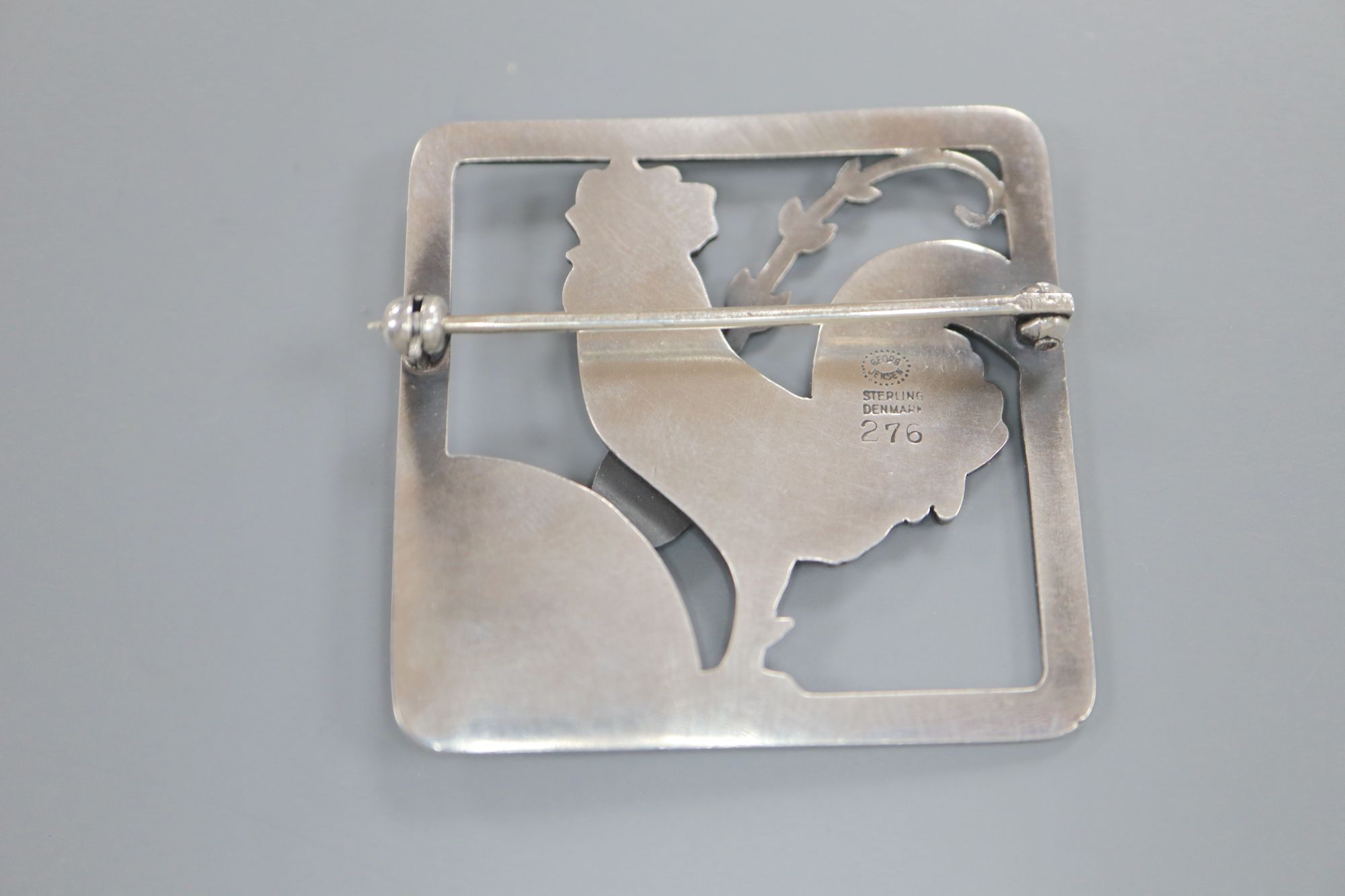 A Georg Jensen sterling Cockerel and foliate spray square brooch